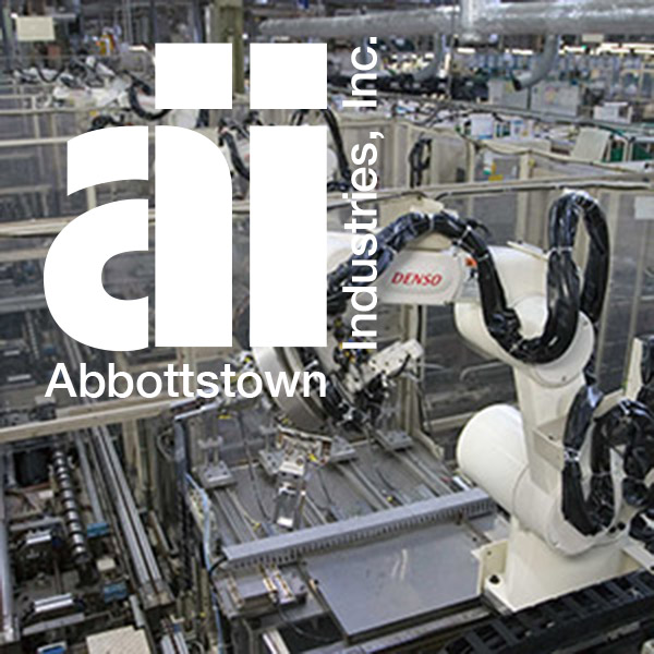 aii logo in front of denso 3 axis robot
